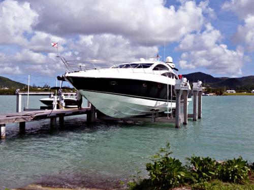 White and Black boat on an 120,000 pound 8-Post Boat Lift in Antigua.