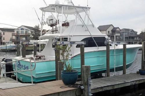 Aqua Blue and white boat on a 40,000 pound 8 post boat lift installed in North Carolina.