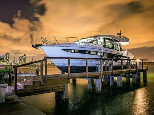 White and black boat on an 80,000 pound 8-Post boat lift in Miami.