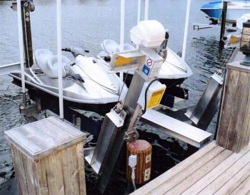 Top view of two silver jet skis on an elevator pwc lift.