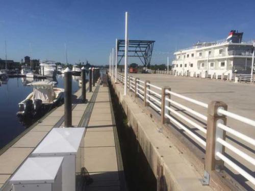 railed walkway overlooking a concrete floating dock